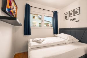 a bed in a room with a window at Holiday&Stay, Tiny living in Fronreute