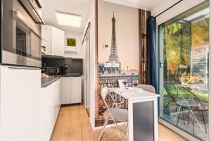 a kitchen with a table and a view of the eiffel tower at Holiday&Stay, Tiny living in Fronreute