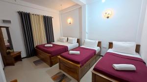 a room with two beds with purple sheets at Akshayaam Villa in Kotagala