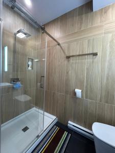 a bathroom with a tub and a glass shower at Cocagne Ocean Suites- Bed & Breakfast in Cocagne  +23 photos