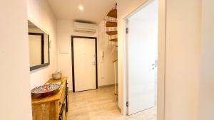 a hallway with a door leading into a room at Imperial Golden Suite by Ca-Sa Check in Chioggia