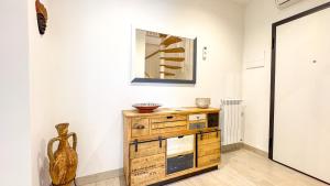 a museum exhibit with a wooden dresser and a mirror at Imperial Golden Suite by Ca-Sa Check in Chioggia