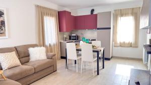 a living room with a couch and a table with white chairs at Imperial Golden Suite by Ca-Sa Check in Chioggia +53 photos