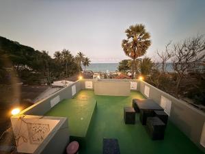 a balcony with a table and a view of the ocean at Diving Nest in Trincomalee