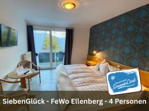 a bedroom with a bed and a chair and a window at Siebenglück - 4 FeWo's mit SommerCard in Winterberg