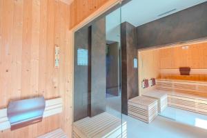 a sauna with wooden walls and a glass wall at Glamping Elba in SantʼAnna +43 photos