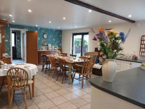 a kitchen and dining room with a table and chairs at Heskin Farm in Burscough