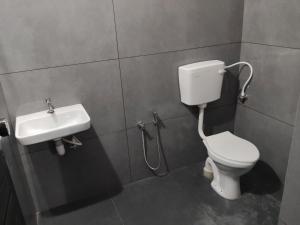 a bathroom with a toilet and a sink at Little Eden in Cochin