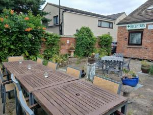a wooden table and chairs in a yard at Heskin Farm in Burscough