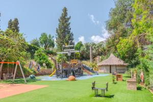 a park with a playground with a slide at Glamping Elba in SantʼAnna