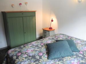 a bedroom with a bed and a green cabinet at Casa Hella by fewotessin in Lavertezzo