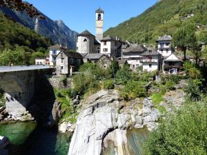 a town on a mountain with a bridge and a river at Casa Hella by fewotessin in Lavertezzo