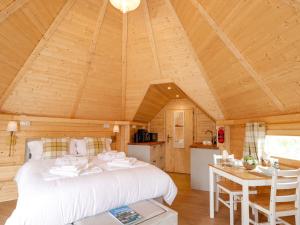 a bedroom with a bed and a table in a room at Little Luxe Lodges 1 in Kyle of Lochalsh