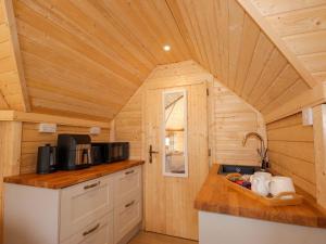 a kitchen with a counter top with a microwave at Little Luxe Lodges 1 in Kyle of Lochalsh +18 photos