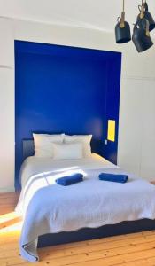 a blue bed with two blue pillows on it at Domaine de Treuillaud in Villers-les-Ormes