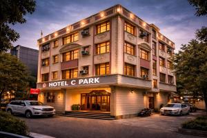 a building with cars parked in front of it at Hotel C Park, Karol Bagh, New Delhi in New Delhi