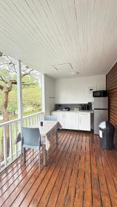 a room with a table and a kitchen on a deck at Hippo Waterfront Lodge in Nelspruit