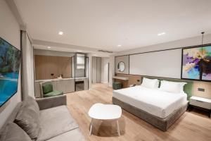 a hotel room with a bed and a couch at Boe Luxury Hotel in Sarandë