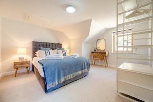 a bedroom with a bed and a desk and a window at 4 Bed in Newquay oc-b27906 in Newquay