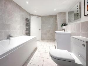 a bathroom with a tub and a toilet and a sink at 4 Bed in Newquay oc-b27906 in Newquay +38 photos