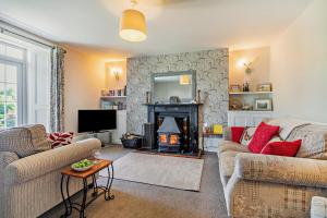 a living room with a couch and a fireplace at 3 Bed in Uphill oc-n27747 in Linkinhorne
