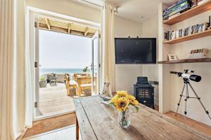 a living room with a table and a view of the ocean at 2 Bed in Croyde oc-r27591 in Croyde