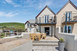 a house with a patio with a table and chairs at 2 Bed in Croyde oc-r27591 in Croyde