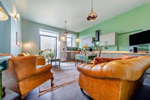 a living room with leather furniture and a kitchen at 2 Bed in Coldstream oc-t30042 in Coldstream