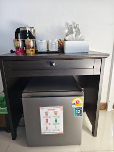 a black table with a trash can under it at Chiang Mai Waroros Boutique Hotel in Chiang Mai