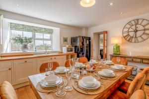 a kitchen and dining room with a wooden table and chairs at 4 Bed in Alyth oc-e31853 in Bridgend of Lintrathen