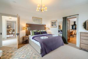a bedroom with a bed and a dining room at 4 Bed in Alyth oc-e31853 in Bridgend of Lintrathen