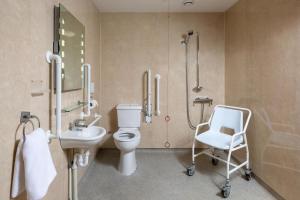 a bathroom with a toilet and a sink and a chair at 9 Bed in Brecon oc-cvelo in Cray +74 photos