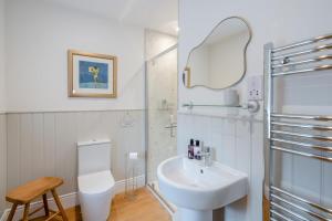 a white bathroom with a sink and a toilet at 4 Bed in Alyth oc-e31853 in Bridgend of Lintrathen +37 photos