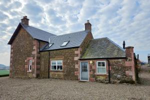 an old brick house with a window and a door at 4 Bed in Alyth oc-e31853 in Bridgend of Lintrathen