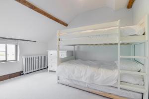 a white bedroom with a bunk bed and a window at 3 Bed in Crayke oc-y056 in Crayke