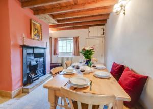 a dining room with a wooden table and a fireplace at 3 Bed in Crayke oc-y056 in Crayke
