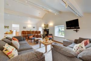 a living room with two couches and a tv at 5 Bed in Muker oc-ds1056 in Muker