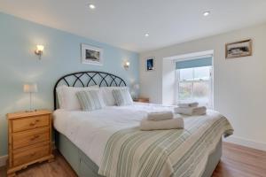a bedroom with a large white bed with a window at 5 Bed in Muker oc-ds1056 in Muker