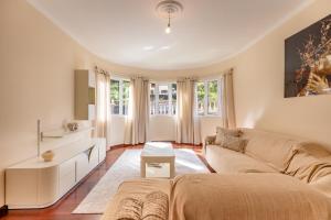 a living room with a couch and a table at The Orange House, By OP in Boaventura