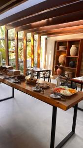 a table with many plates of food on it at Villa Biju in Jericoacoara