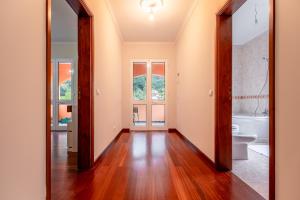an empty hallway with a bathroom with a toilet and a sink at The Orange House, By OP in Boaventura +36 photos