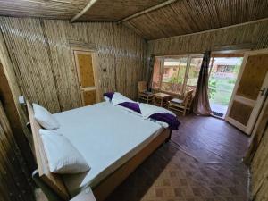 a bedroom with a bed in a wooden room at The Sylvan Hut in Leh