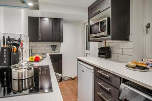 a kitchen with black cabinets and a counter top at 2 Bed in Mumbles oc-v30980 in The Mumbles