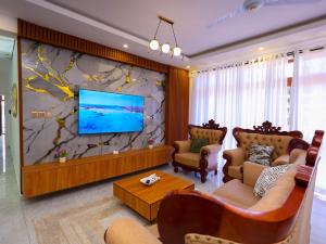 a living room with a large stone wall at Giannas stays 3B in Mombasa