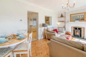 a living room with a table and a fireplace at 3 Bed in Beer oc-d32358 in Beer