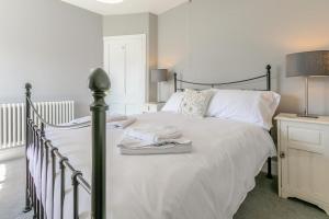 a bedroom with a bed with white sheets and pillows at 3 Bed in Beer oc-d32358 in Beer