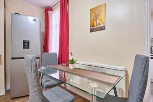 a dining room with a glass table and chairs at Host & Stay - Dover Retreat in Ipswich