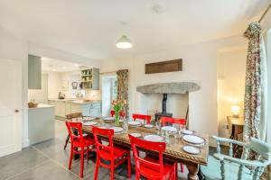 a kitchen and dining room with a wooden table and red chairs at 5 Bed in Ulpha oc-b32731 in Ulpha