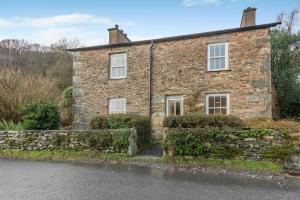 an old stone house on the side of the road at 5 Bed in Ulpha oc-b32731 in Ulpha