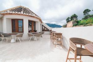 a patio of a restaurant with tables and chairs at Nomada House by SH Hoteles in Denia